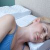 woman's head on a contoured white pillow