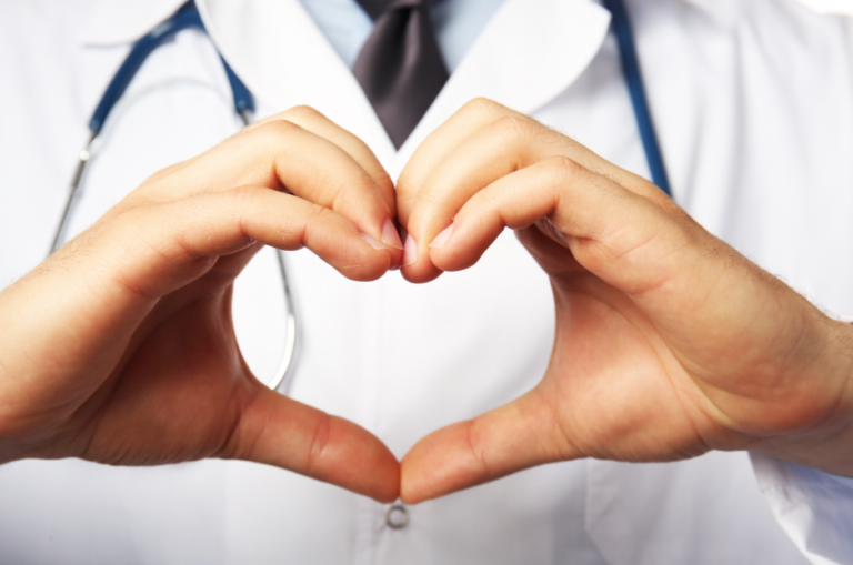 doctor showing a heart through his hands