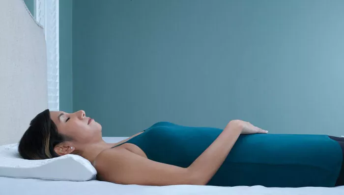 woman fast asleep on a back sleeper pillow