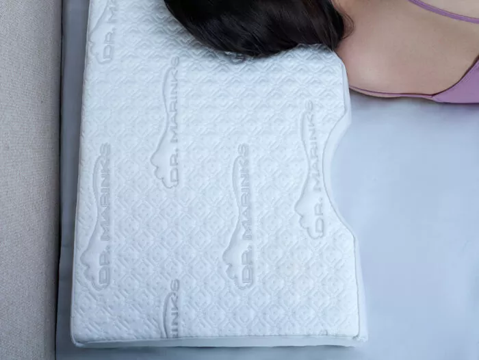 contoured white pillow and a woman fast asleep