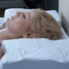 woman fast asleep on a comfy, white pillow