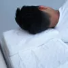 man side sleeping on a Dr. Marinks white sleeping pillow