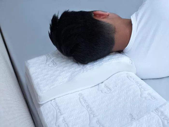 man side sleeping on a Dr. Marinks white sleeping pillow