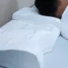 man side sleeping on an elevated part of the white pillow