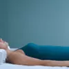 woman back sleeping on a contoured white pillow